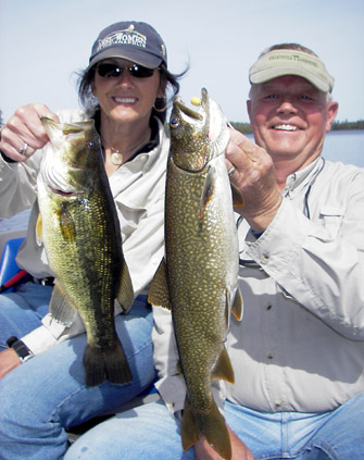 Patti with largemouth bass and Dan with a lake trout