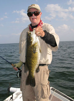 A fly fisher holding a big smallmouth on Lake Michigan