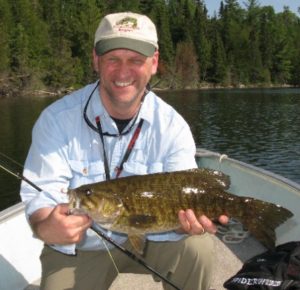 An Ontario guest with a large smallmouth bass