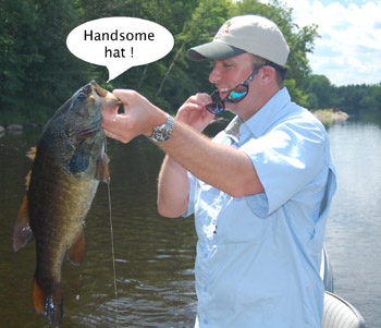 Matt Swenson, holding up a smallmouth and talking to it