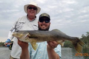 A lodge guide with Jeff's big 28-inch walleye