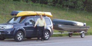 Tim driving with his car, 2 kayaks, a canoe and a johnboat 