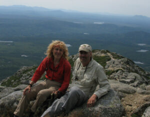 Tim and Lyn on a mountaintop with tiny-looking lakes below