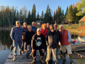A group of 10 lodge guests and Lyn Verthein on the dock at Yoke Lake