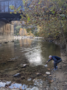 Steve putting Tim's ashes into the Maury River